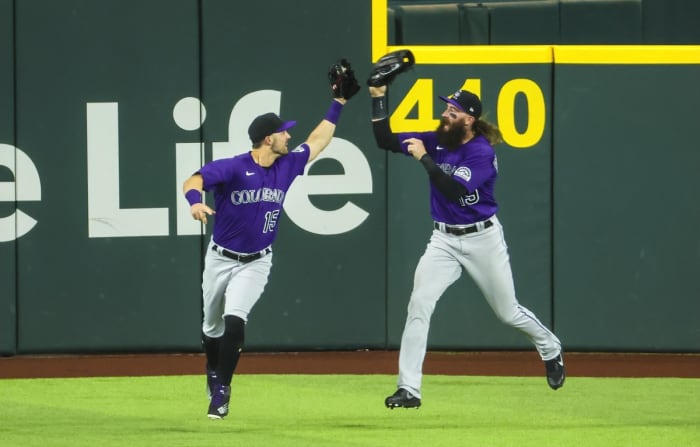 Apr 12, 2022; Arlington, Texas, USA; Colorado Rockies center fielder Randal Grichuk (15) celebrates with Colorado Rockies right fielder Charlie Blackmon (19) after making a catch during the fifth inning against the Texas Rangers at Globe Life Field. Mandatory Credit: Kevin Jairaj-USA TODAY Sports